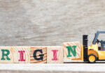 Toy forklift hold letter block n to complete word origin on wood background